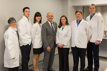 Silvia Ferretti, D.O. of LECOM with the five recipients of the Highmark Scholarship. 