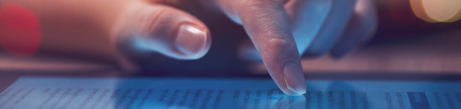 Person's hand scrolling through news article on tablet Image