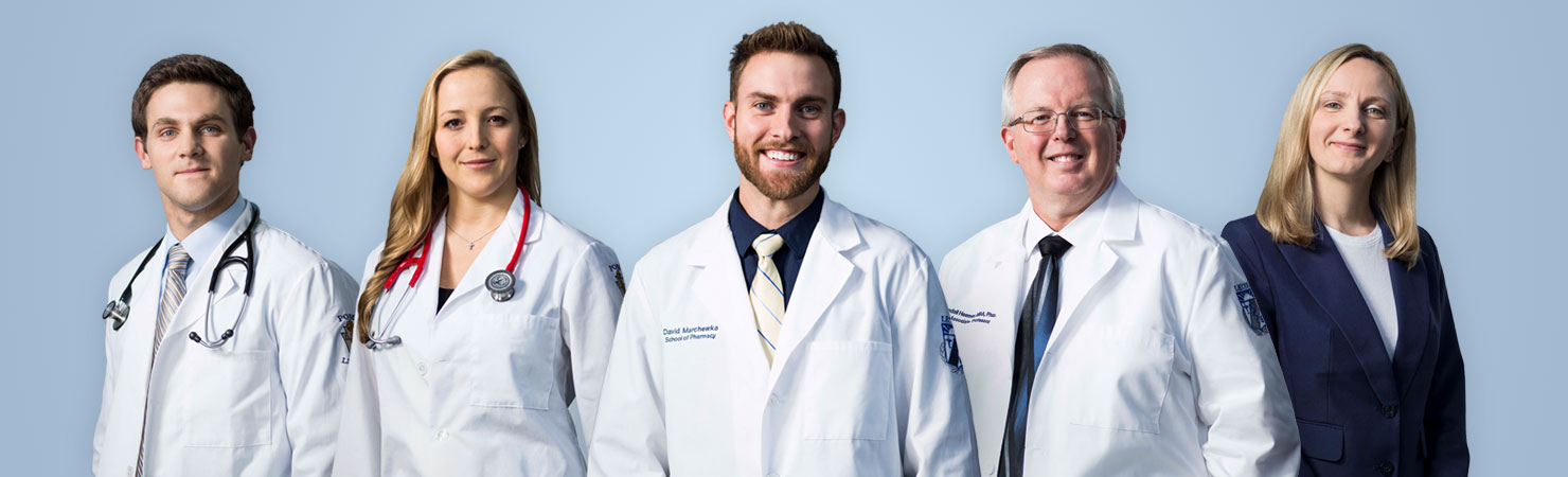 Two female and three male medical professionals in white coats at LECOM