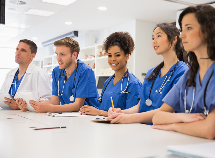 Students in blue scrubs in classroom at LECOM in Erie, PA