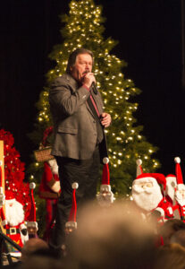 Auctioneer, Corey Brown, drives up the bids during the live auction for LECOM.