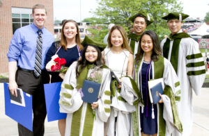 LECOM Erie Graduates standing outside Erie Insurance Arena for a group photo.