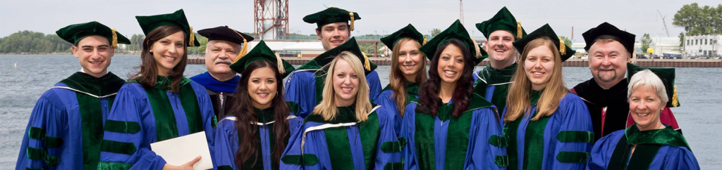 Young graduates posing for photo at dock in Erie PA by LECOM