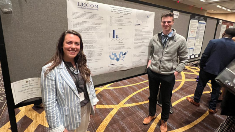 Katherine Dobosh (left) and Jacob Oslosky (right) stand with their presentation.