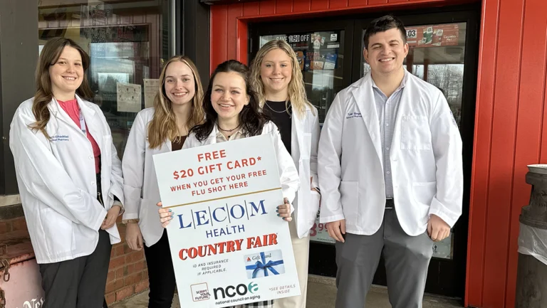 LECOM Pharmacy students holding award in front of Country Fair Store